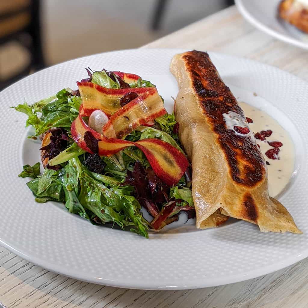 Spelled pancake stuffed with candied duck, Migneron de Charlevoix, caramelized onion and cranberry, hash brown, salad